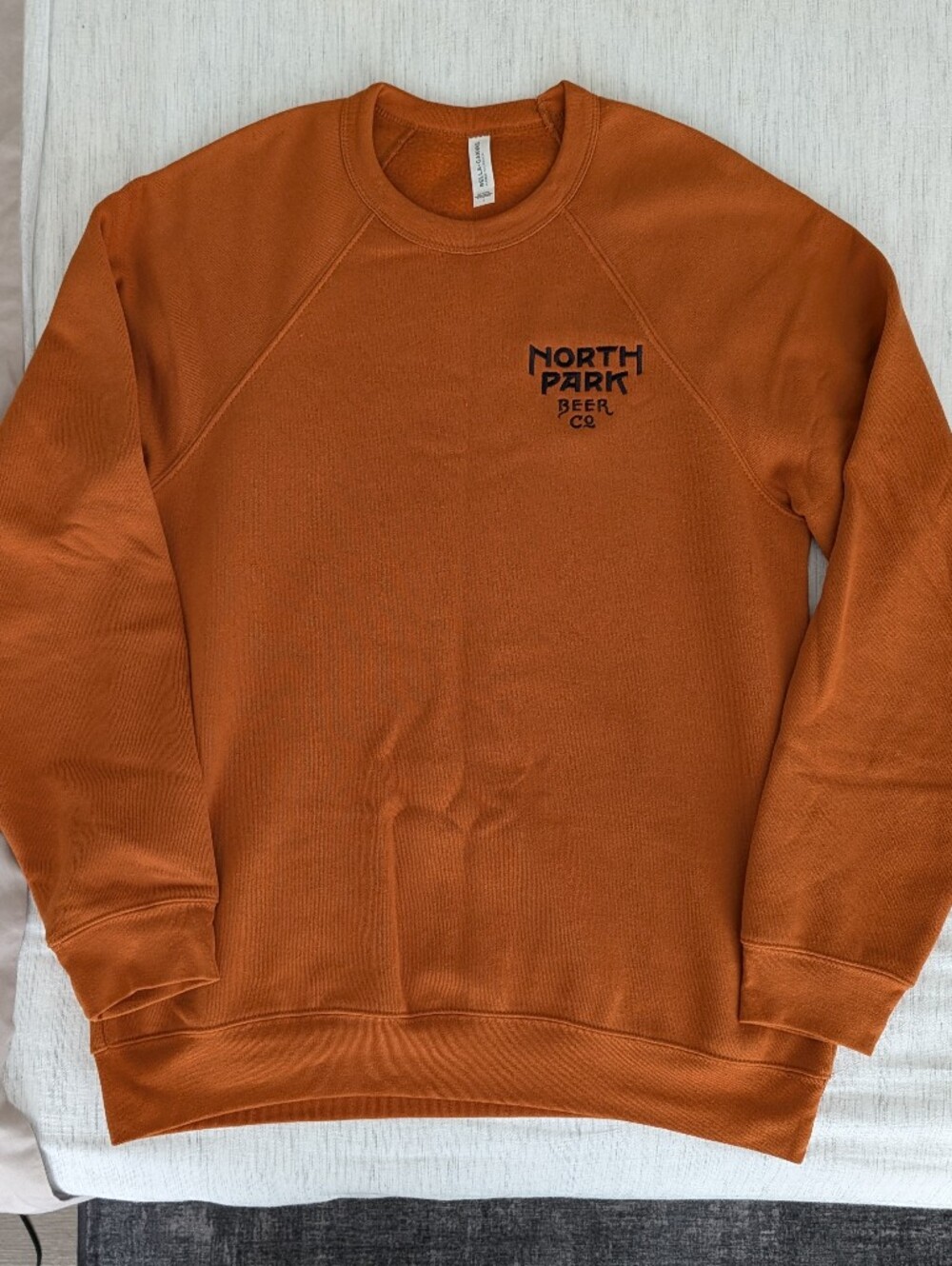 Bella Canvas North Park Beer Co - Men's Crewneck Sweater in Burnt Orange